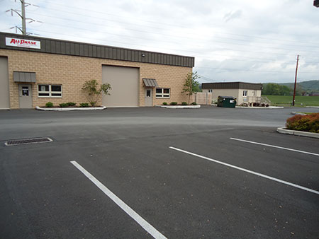 A picture of the parking lot after being painted for parking and handicap zones