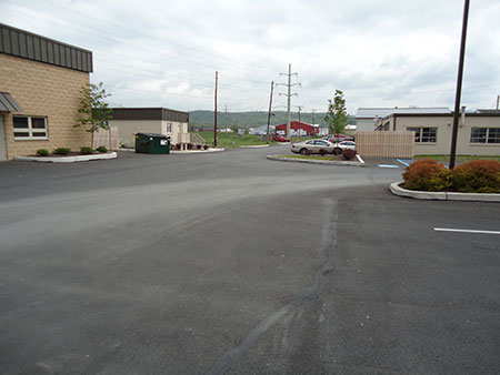 A perspective shot of the parking lot as it fits with the other buildings at the Industrial Park