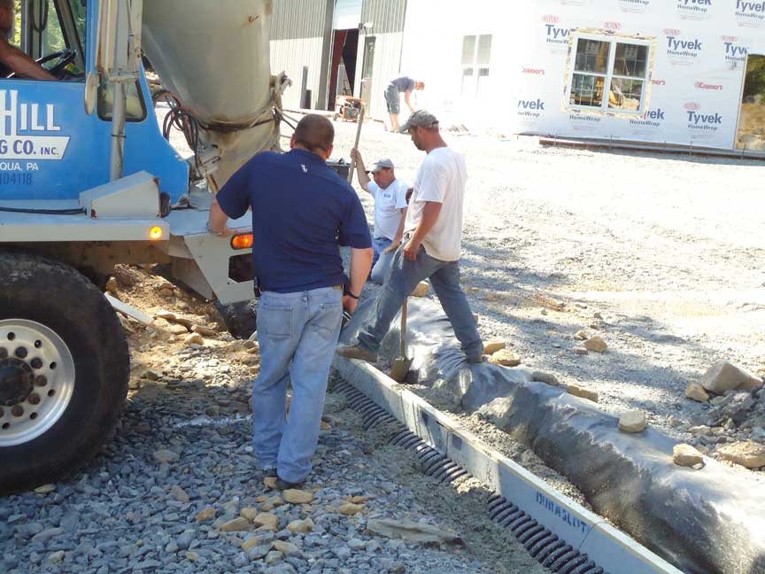 Crew pouring concrete for the curbing and sidewalks