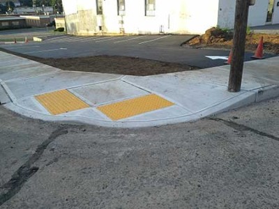 Picture of the corner sidewalk installed at second parking lot with metal handicapped accessable slabs.