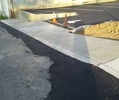 Picture of the drain installed and curbing and the tranistion pavement into the existing highway